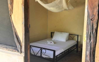 Double bed in affordable comfort budget rooms in garden of the accommodation Kwa Simba in Pangani, Tanzania, Africa