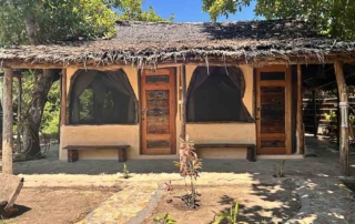 Outside terrace and garden of budget rooms made with natural materials in Kwa Simba accommodation in Pangani, Tanzania Africa.